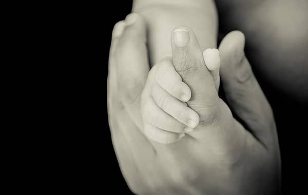 newborn holding hand